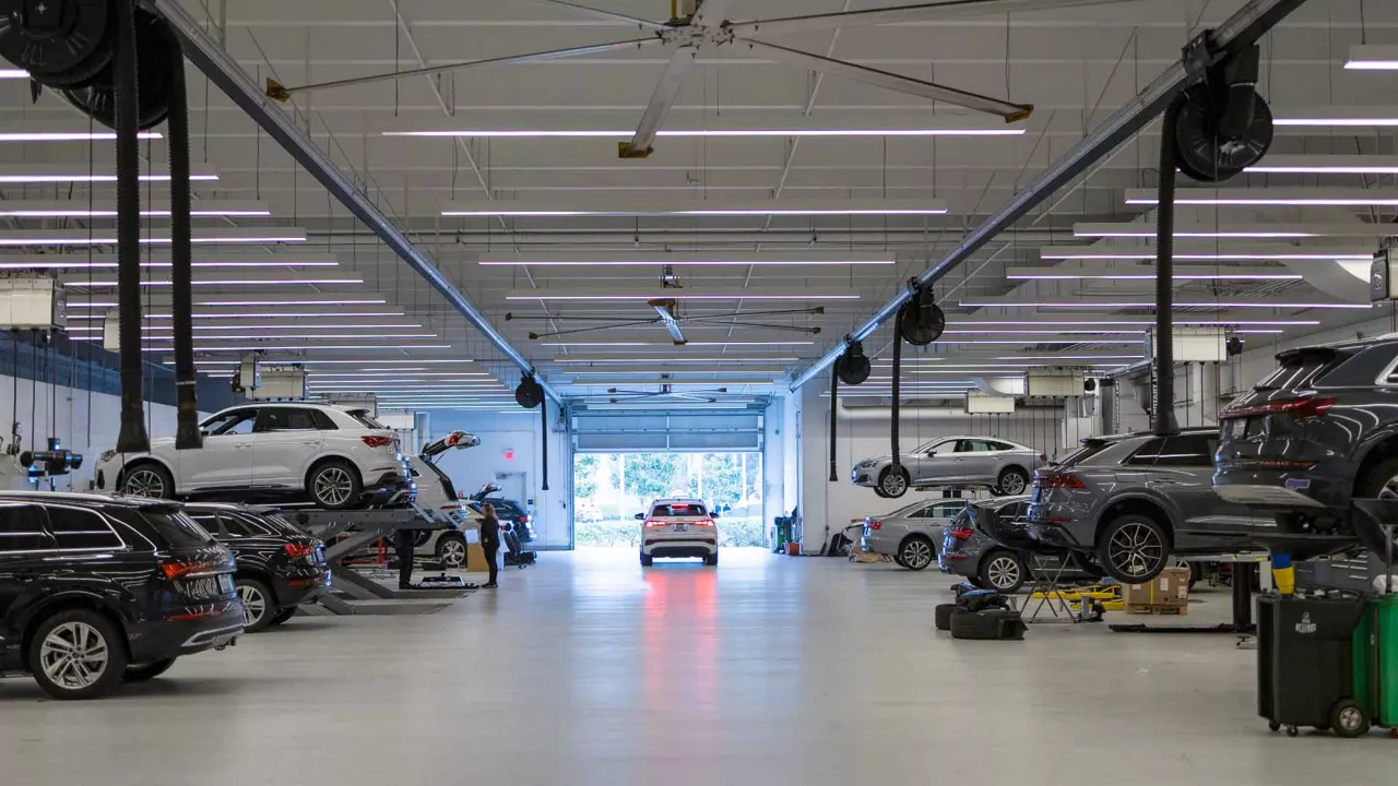Audi service technician servicing a vehicle.