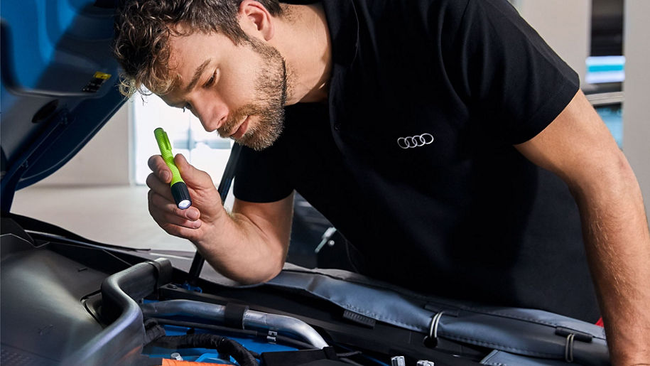 Service technician servicing a tire with another technician.