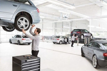 Service technician servicing vehicle. 