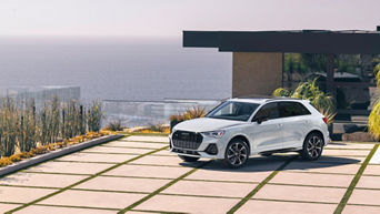 Side profile of an Audi Q3 parked. 