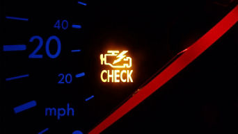 Check engine light illuminated on a car dashboard.