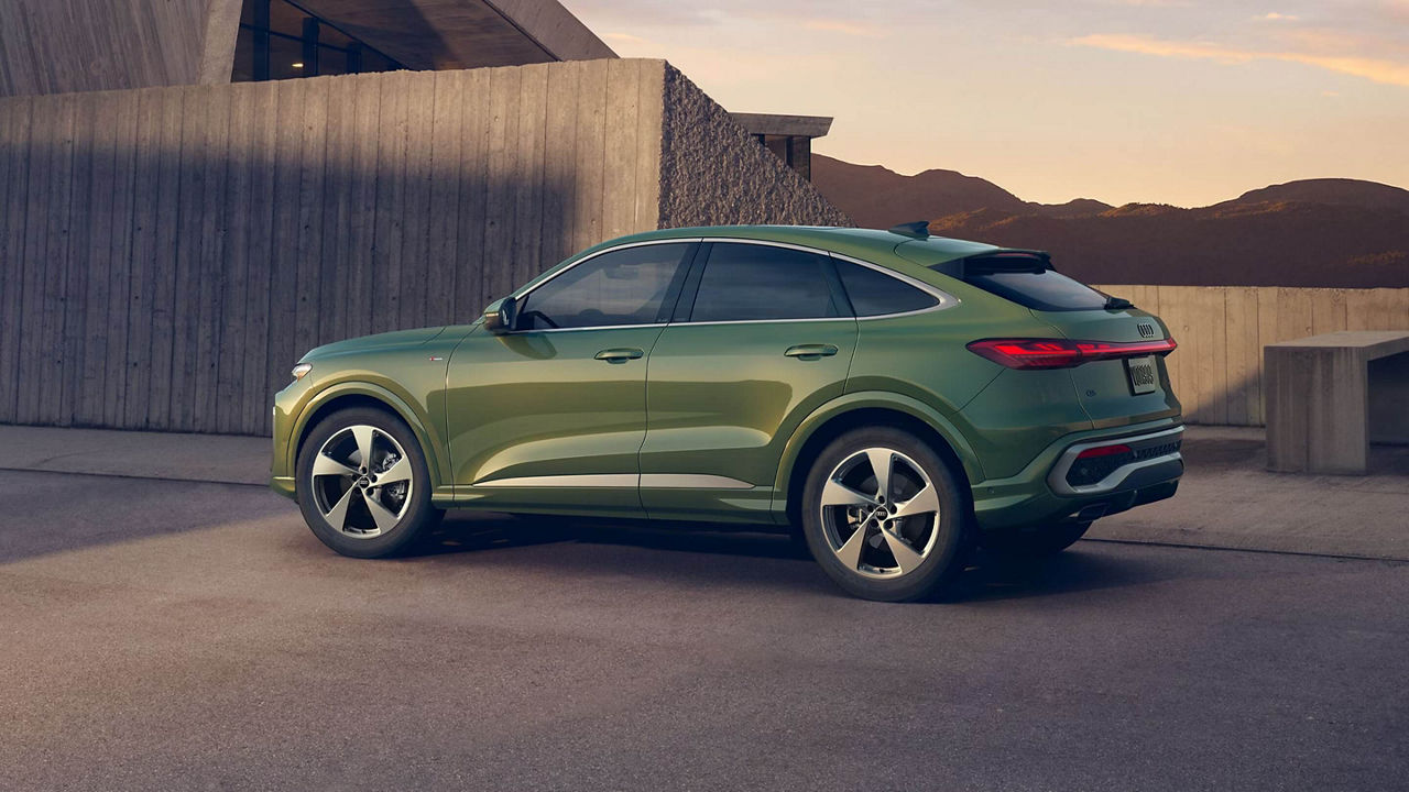 Rear 3/4 view of a green Audi Q5 SUV