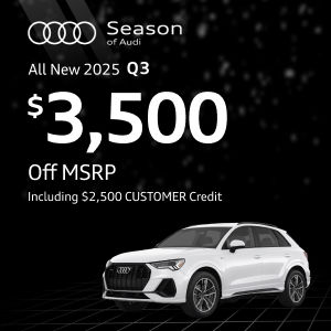 Side view of an Audi Q3 driving.