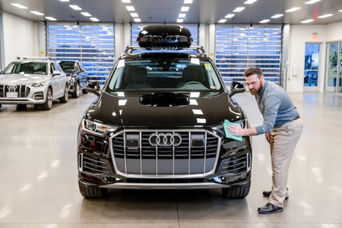 An Audi technician servicing a vehicle
