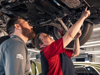 Service technician serving vehicle.