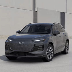 Left side profile of an Audi Q6 accelerating.