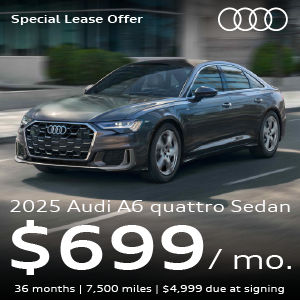 A gray Audi A6 driving.