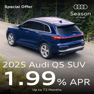 A blue Q5 parked in the forest.