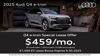 Three quarter view of an Audi q4 e-tron driving with trees in the the background.