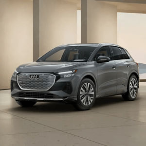 Front 3/4 view of a grey Audi Q4 e-tron parked in a modern building