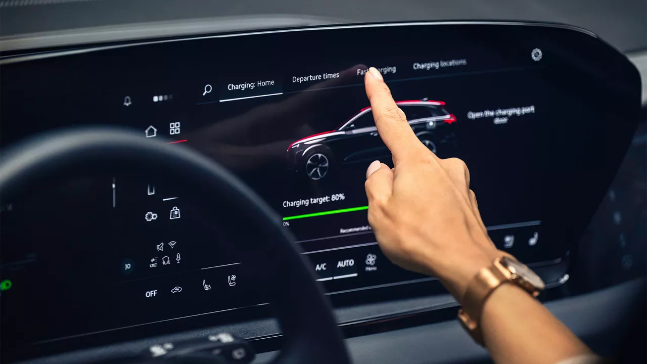 View of consumer navigating the dashboard touchscreen inside an Audi vehicle