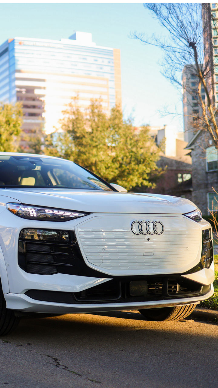 Audi 2025 Audi Q6 e-tron left profile driving.