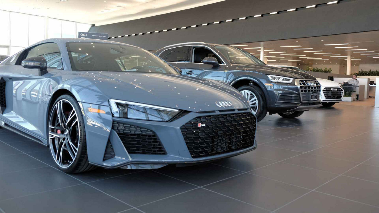 Close-up front view of a line-up of Audi vehicles. 