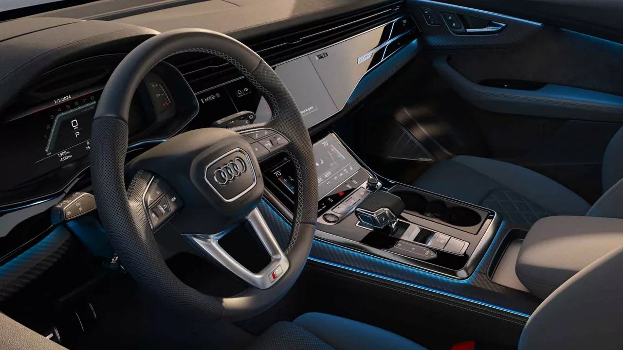 Close-up of the steering wheel and console in an Audi vehicle. 