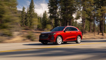 Three-quarter side profile view of an Audi Q5 accelerating.