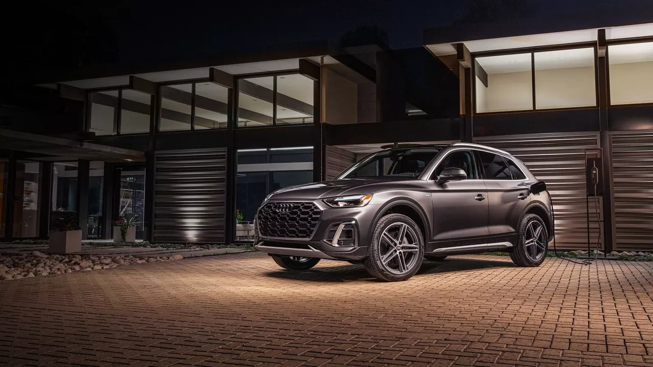 Side profile view of an Audi Q5 PHEV parked.