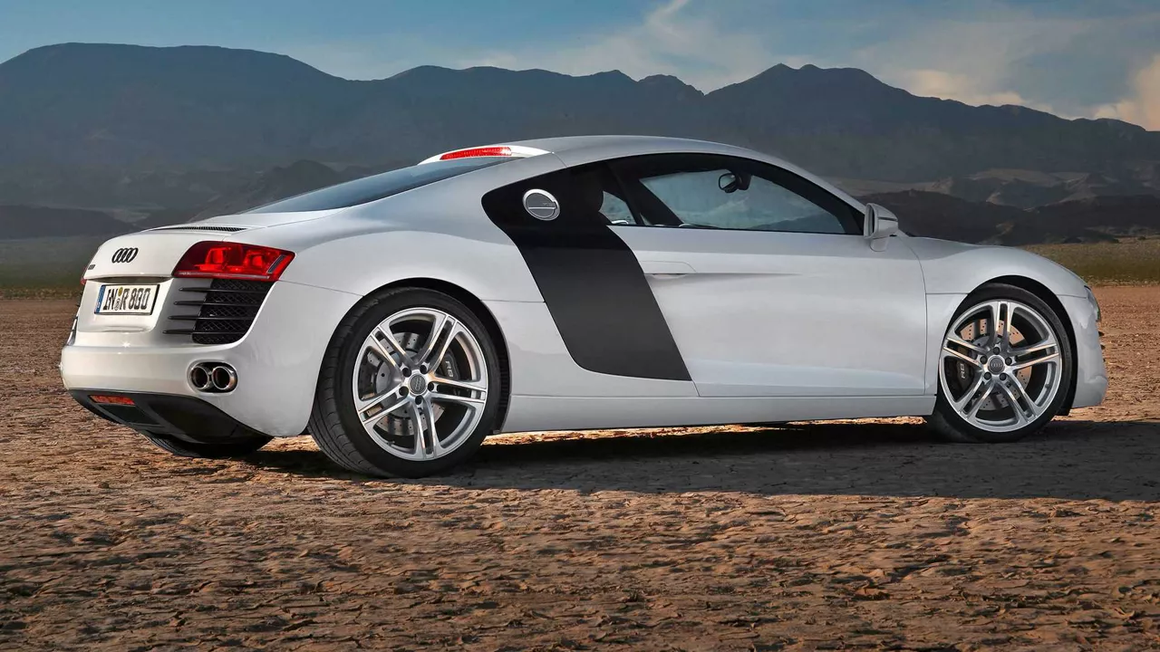 Exterior rear three-quarter side profile view of an Audi R8, parked.