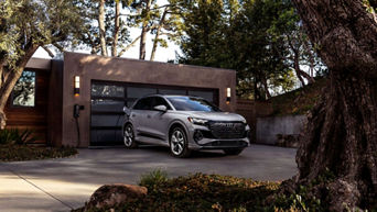 Three quarter side profile view of an Audi Q4 e-tron parked.