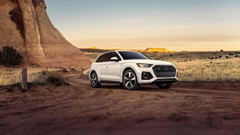 Three-quarter front view of an Audi Q5 accelerating. 