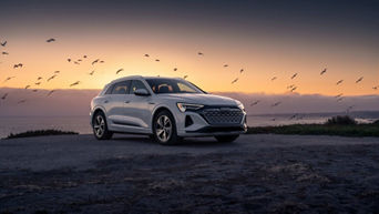 Three quarter side profile view of an Audi Q8 parked.