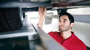Service technician servicing tire.