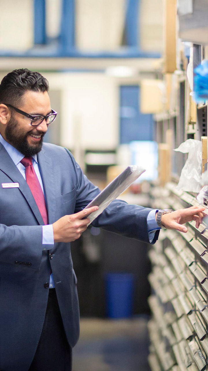 A Parts associate finding an Audi part for a customers.