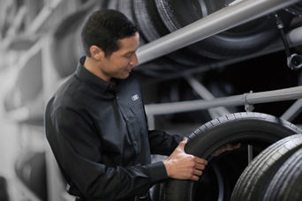 Service technician servicing tire.