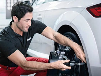 Service technician servicing tires.