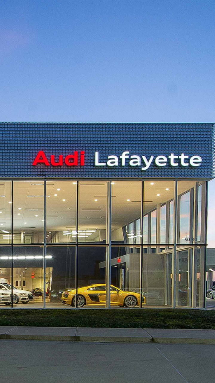 Audi Sale Specialist walking through the showroom with a couple.
