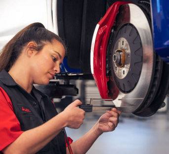 Service technician serving vehicle.
