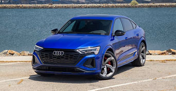 Blue Audi Car parked in front of the water