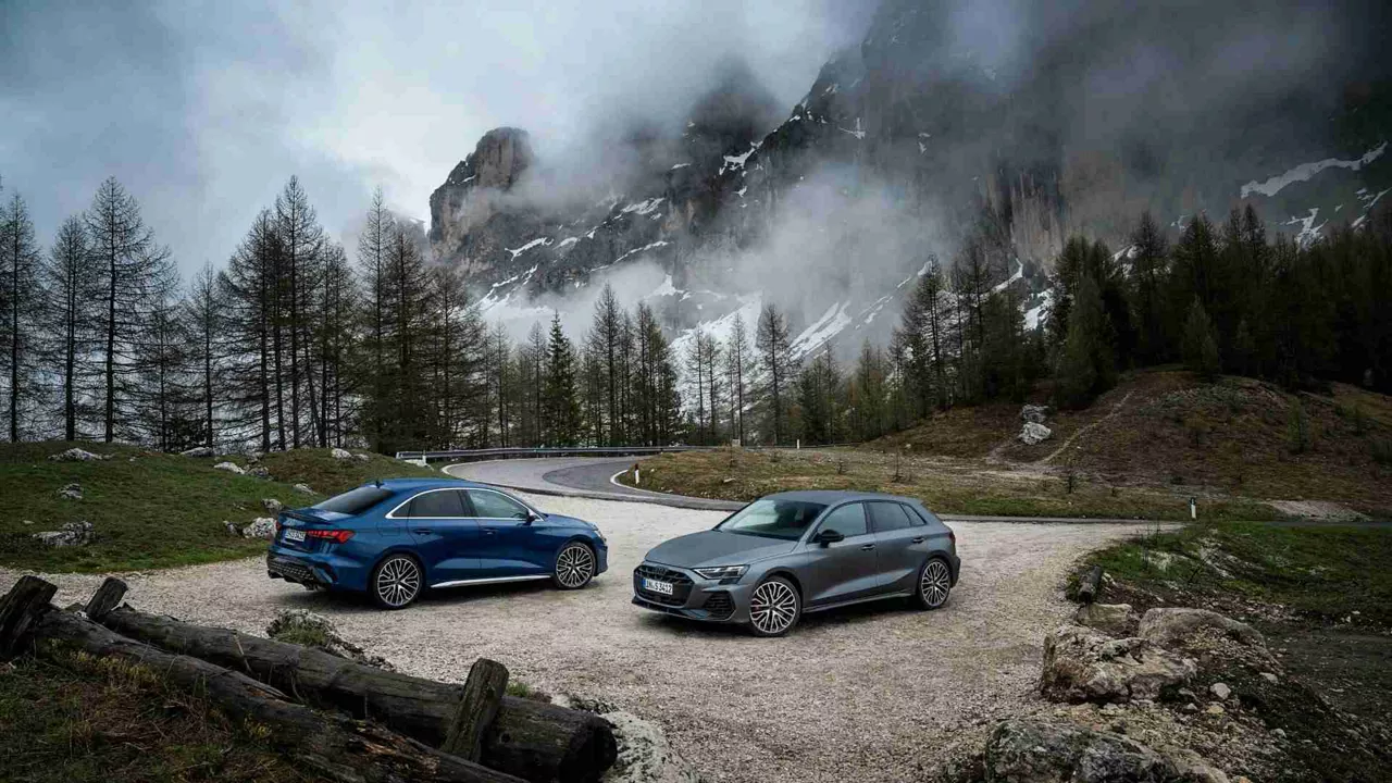 side profile view of two audi s vehicles parked.
