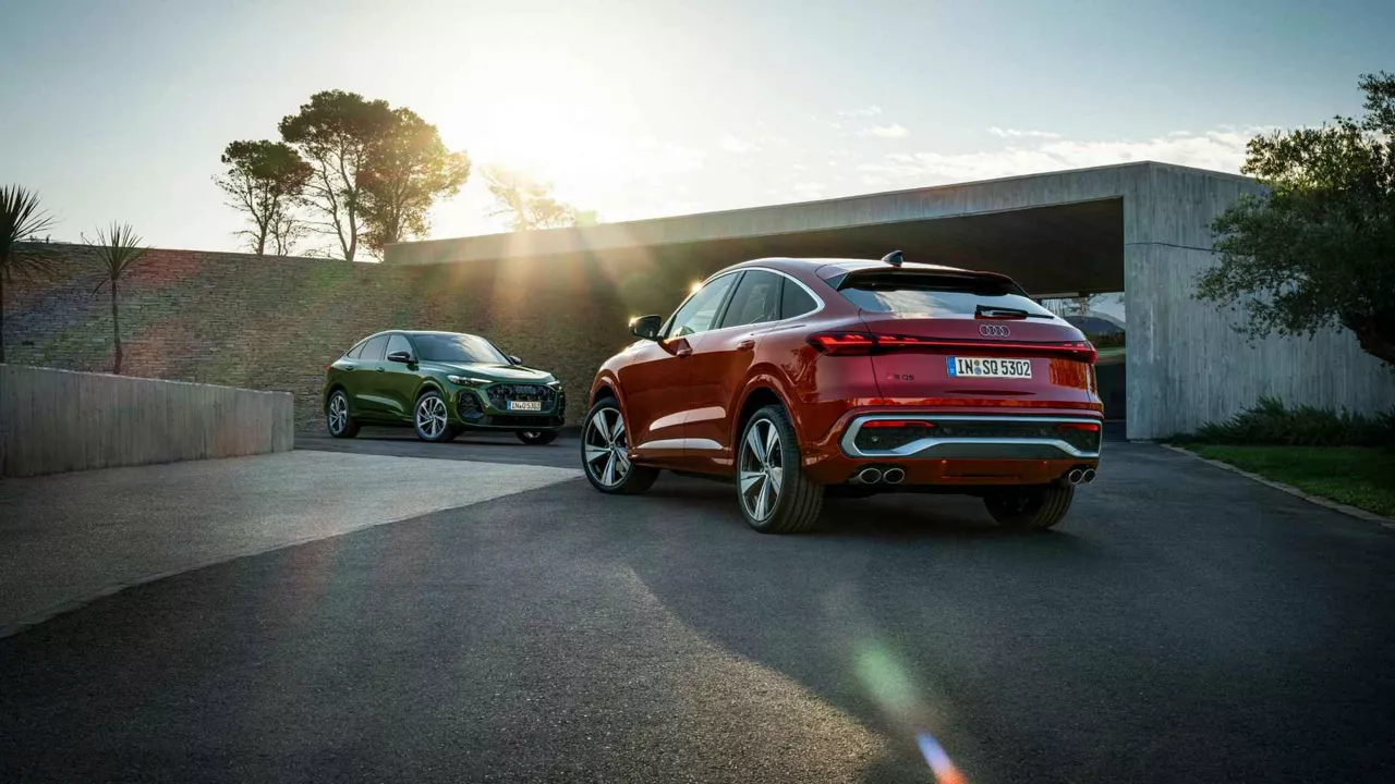 Rear profile view of two audi SUV's parked.