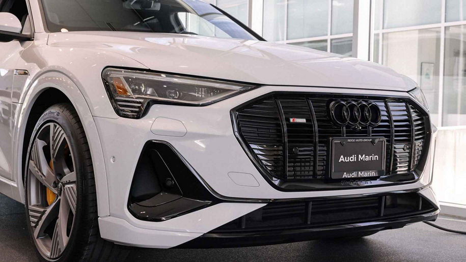 Three quarter view of an Audi E-tron parked.