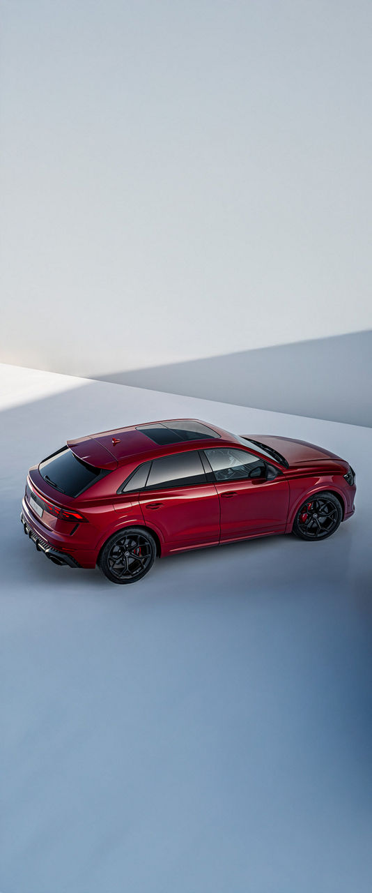 2025 Audi RS Q8 in red exterior photo from top down parked in an abstract grey background