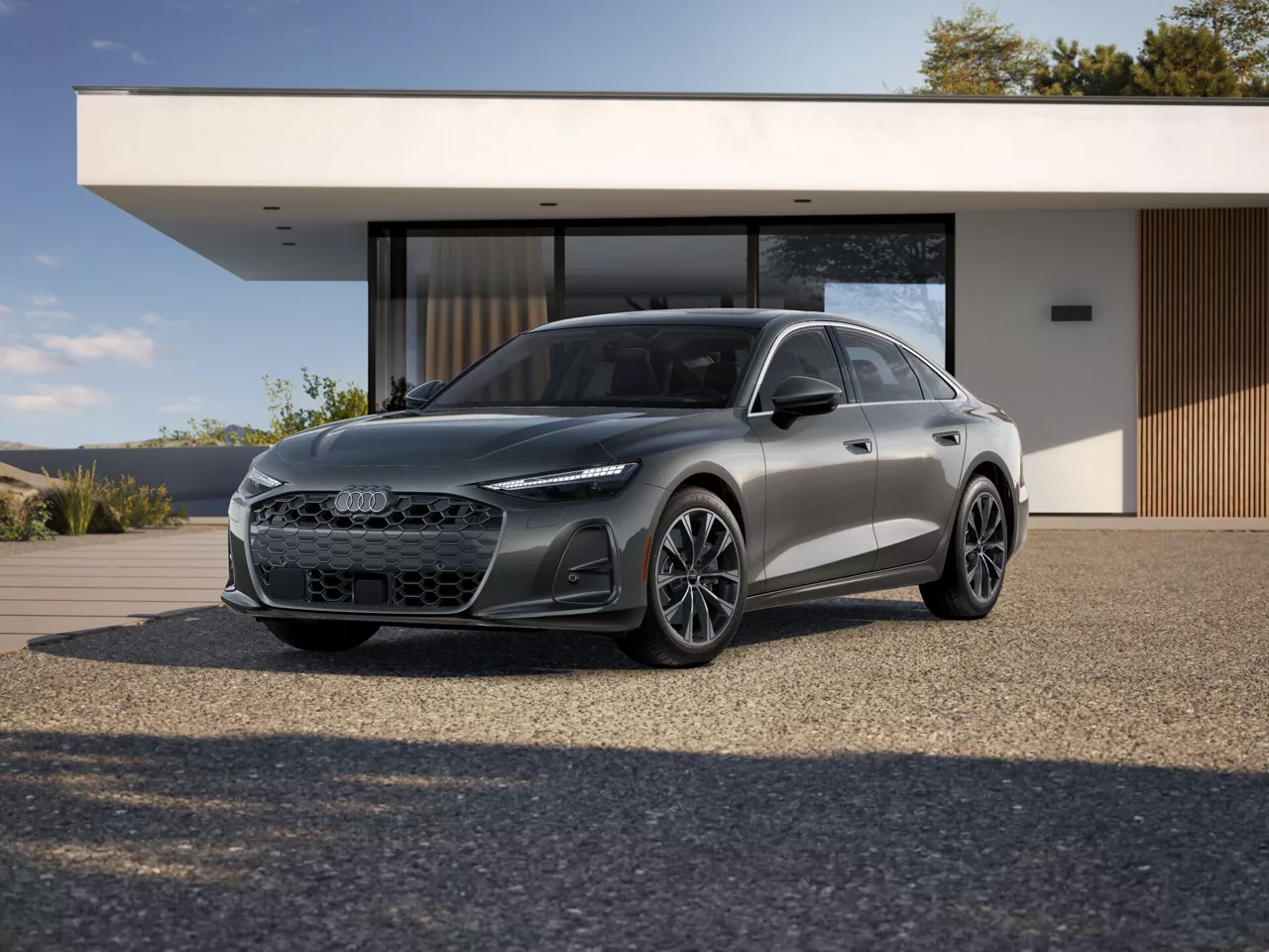 2026 Audi A6 Premium Plus trim level im grey paked in front of modern house