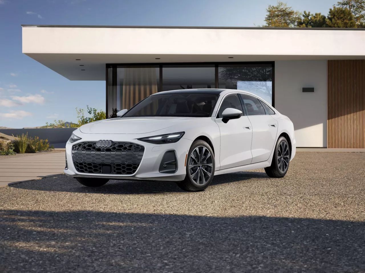 2026 Audi A6 Premium trim in white parked next to a modern house