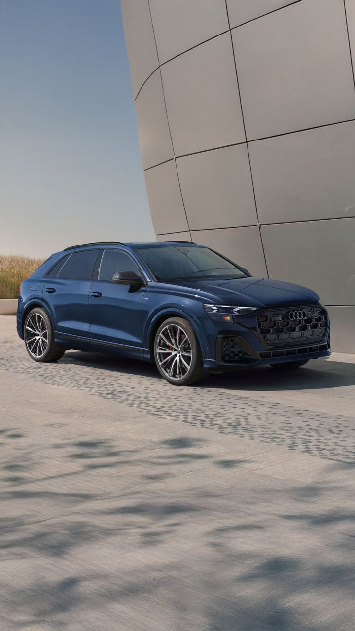 2026 Audi Q8 trim level in blue parked by modern building