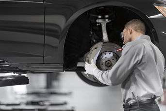 Service technician inspecting brakes.