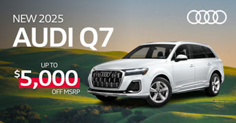 Front facing view of an Audi Q7 accelerating.