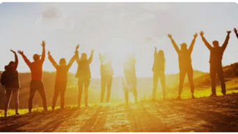 Employees standing together with sunlight shining above