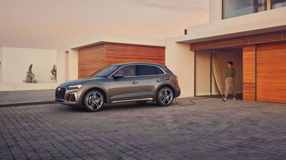 Left profile view of an Audi SUV parked in driveway.