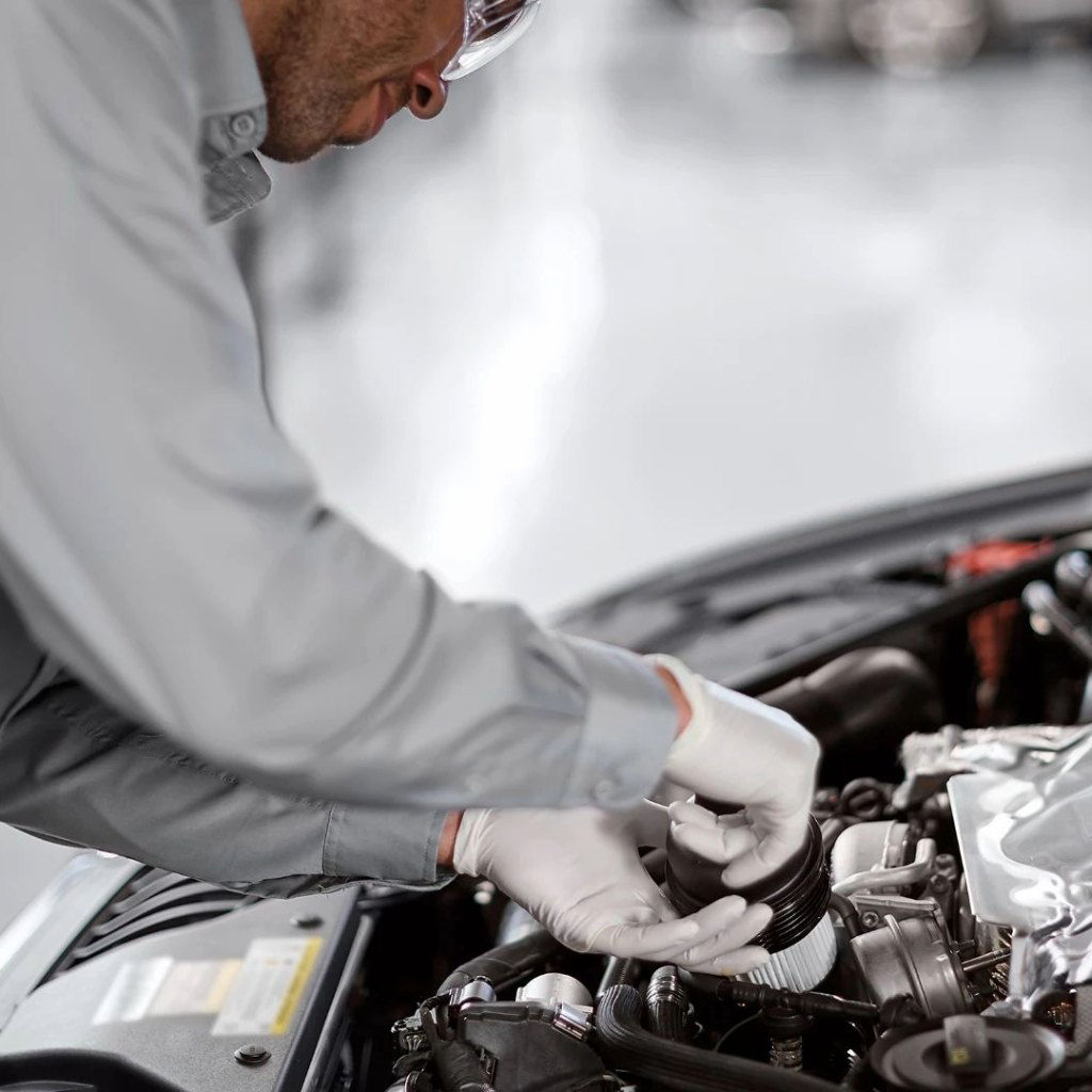Technician servicing an Audi engine.