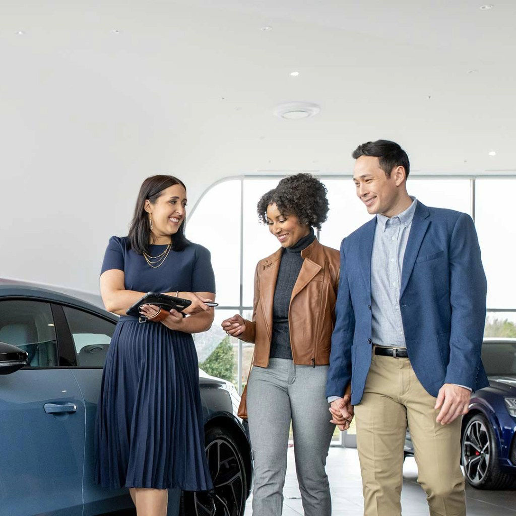 Audi Sale Specialist walking through the showroom with a couple.