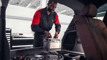 Service technician servicing battery.