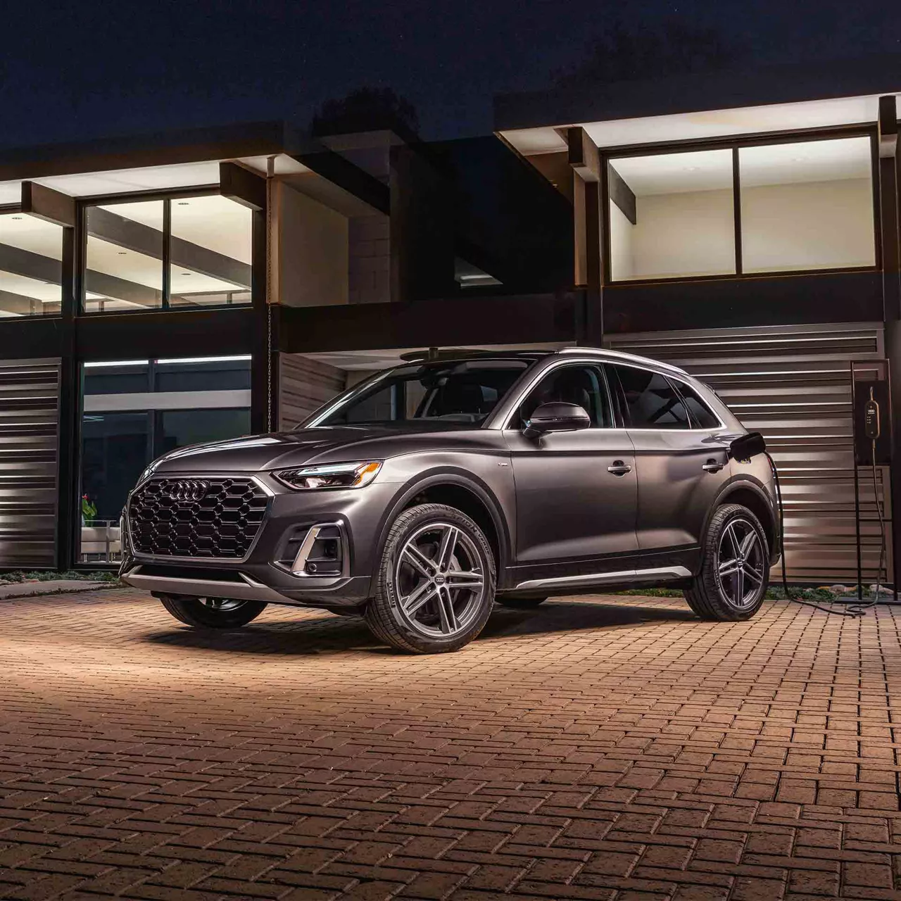 Audi parked in driveway at night