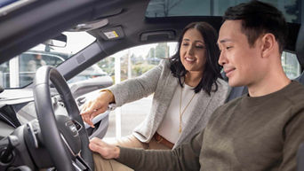 Audi Sales Specialist talking with a customer.