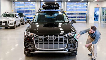 Audi worker inspecting vehicle. 