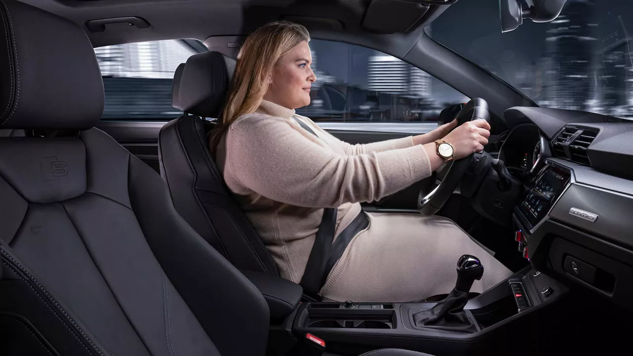 Woman driving an Audi Q3 and accelerating