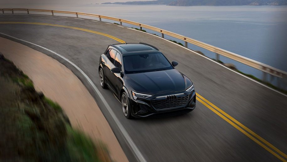 Aerial view of an Audi Q8 e-tron® driving down a road. 
